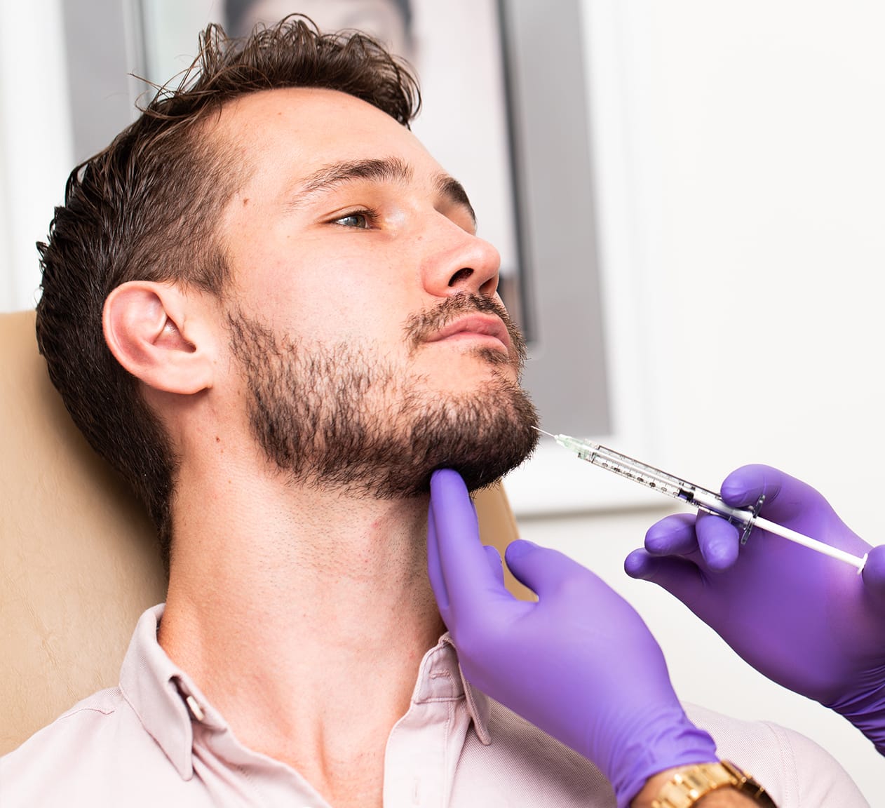 man receiving botox injections in the chin